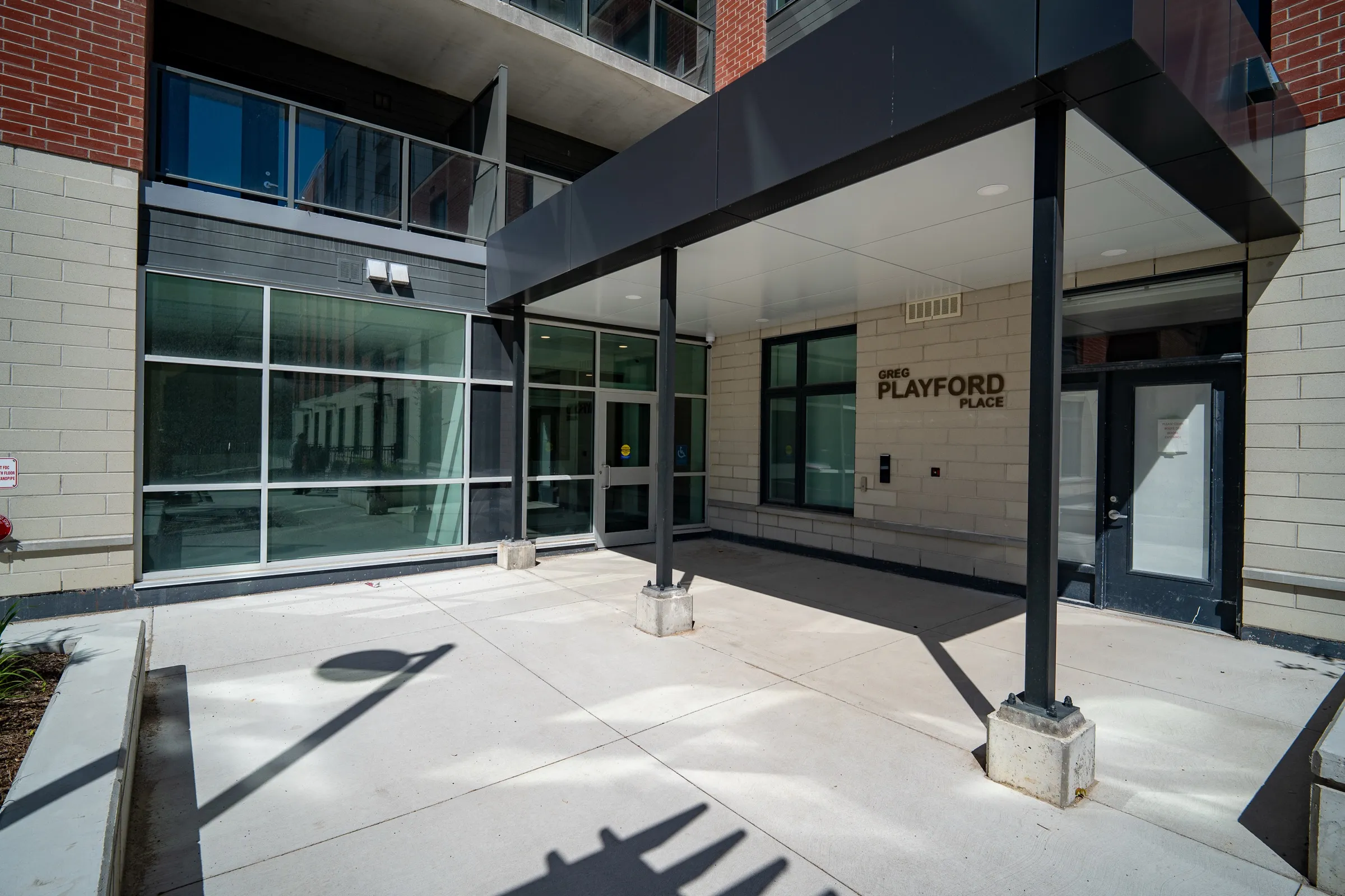 Exterior of Greg Playford Place, brick with balconies on every floor