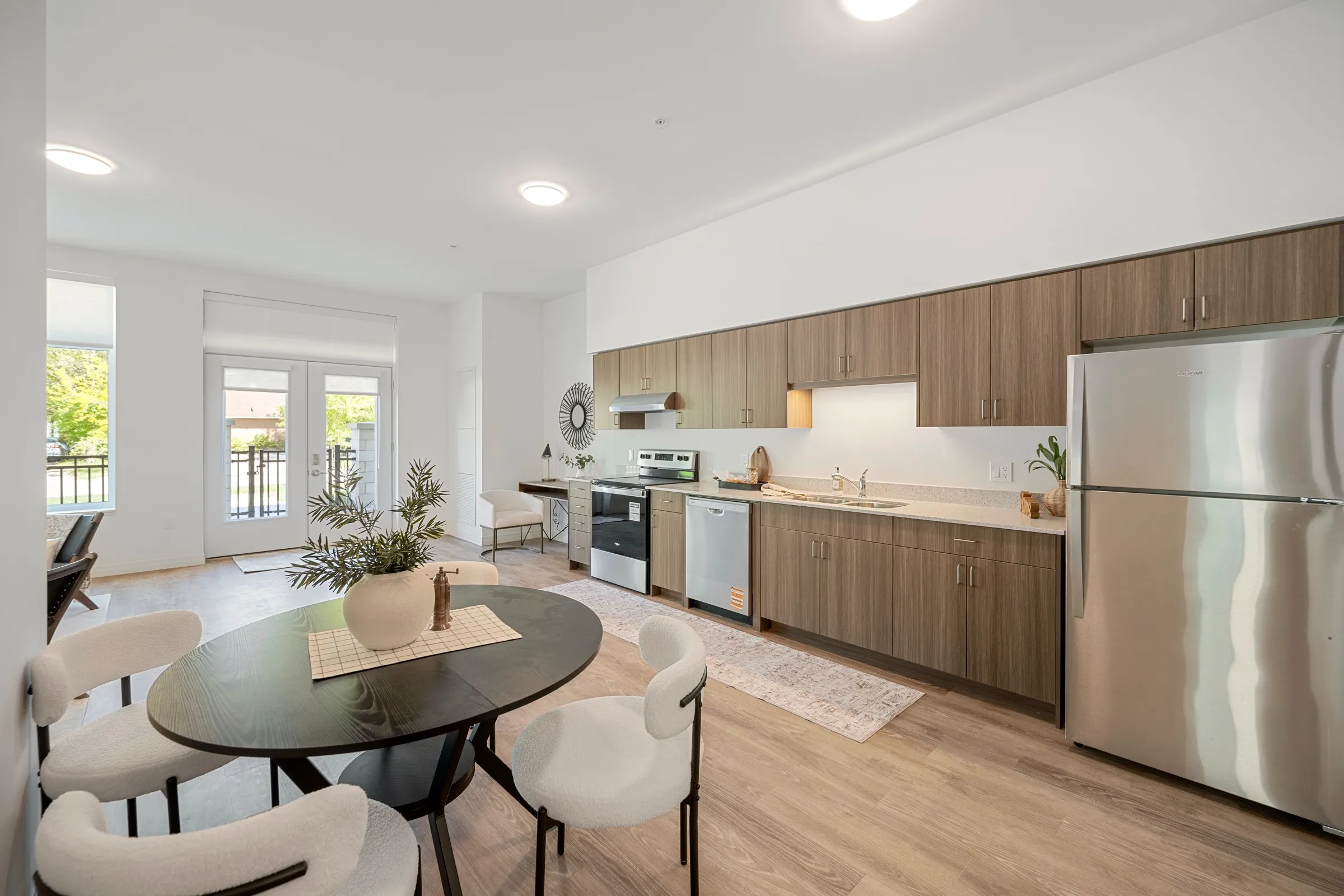 Kitchen with dark wood cabinets, a range and a dining table beside it