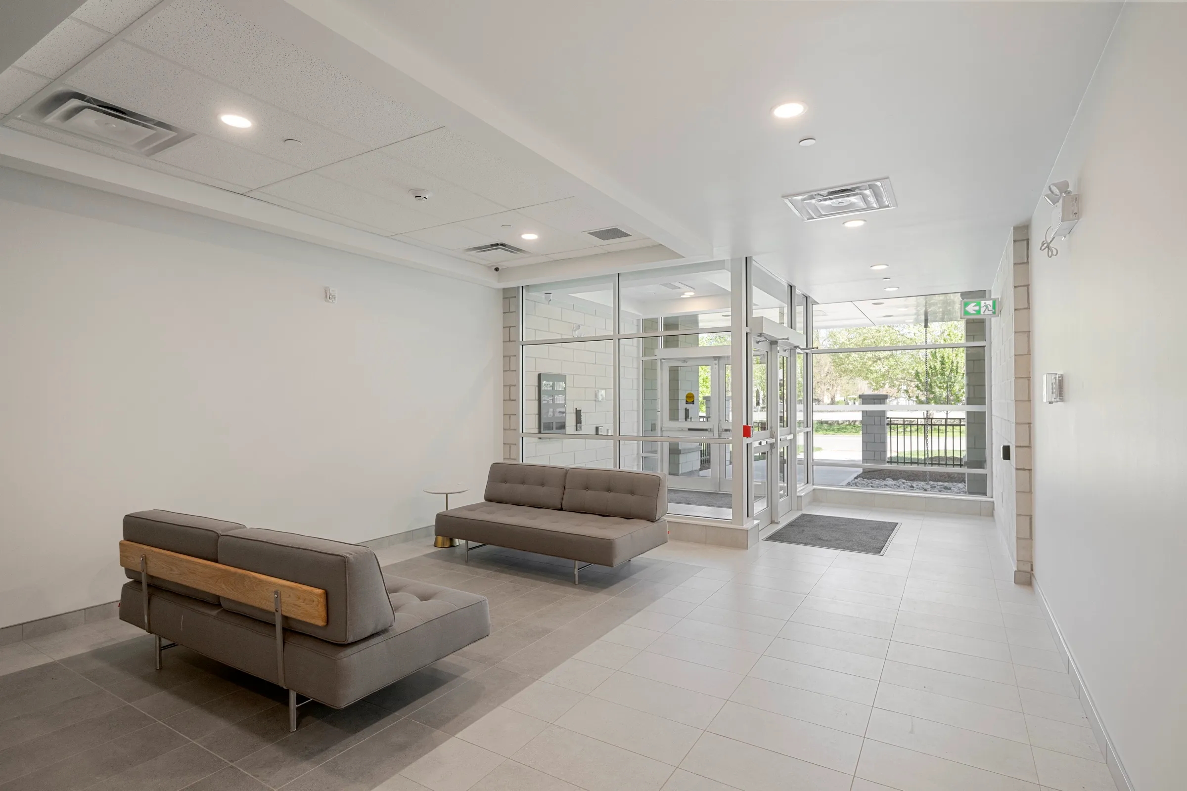 Lobby with glass entry doors, seating and secure access